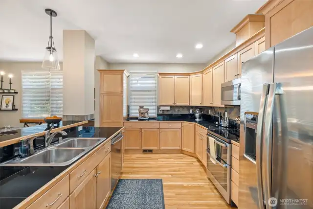 This is truly a chef’s dream kitchen with custom cabinets, stainless steel appliances, granite countertops, and hardwood floors.