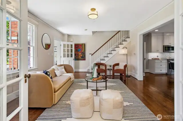 A seamless blend of past and present unfolds as you move from the refined living room to the light-filled kitchen beyond. The central stair, lovingly preserved, links generations—while warm oak floors and gentle transitions offer a canvas for modern life, deeply rooted in place.