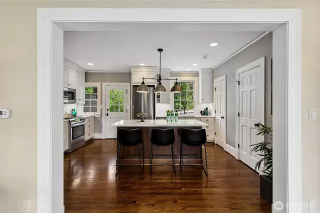 Anchored by a generous island and adorned with Miele appliances, the kitchen brings quiet luxury to everyday rituals. Thoughtfully updated within the original footprint, it offers a place to gather, nourish, and create—framed by verdant views that echo the home’s parkland setting.