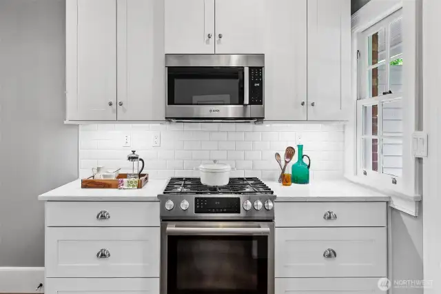 A study in balance: clean subway tile, polished hardware, and a top-tier gas range sit quietly within the home’s historic frame. This is a kitchen made for both craft and comfort—where evening meals and lifelong memories simmer side by side.