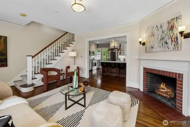 Original brickwork cradles the hearth, while gentle stairs rise toward the sleeping quarters above—each element restored with care, preserving both function and feeling. In this warmly layered space, the past offers not constraint, but continuity.
