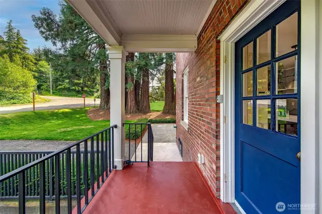 Step through the cobalt-blue door and into a world set apart—where mornings begin with the rustle of leaves and evenings end in the long hush of twilight. This covered side porch, once trodden by uniformed feet, now welcomes a gentler rhythm of homecoming.