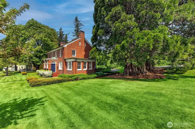 This rare end-lot sanctuary offers one of Fort Lawton’s most expansive and secluded lawns—an open-air canvas for grand outdoor entertaining, spirited games of tag, or the joyful dash of a dog at full stride. Encircled by towering sequoias and verdant parkland, the space invites al fresco dining, firelit gatherings, and quiet moments of reflection. Here, the landscape becomes an extension of the home—a private meadow where history, community, and nature converge in perfect harmony.