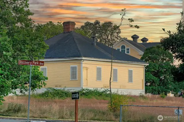 Across the quiet parade grounds, storied buildings stand as sentinels of the past—each one a chapter in Fort Lawton’s long narrative. This former military structure, warmed by the last light of day, reminds residents that here, every walk is a journey through history.
