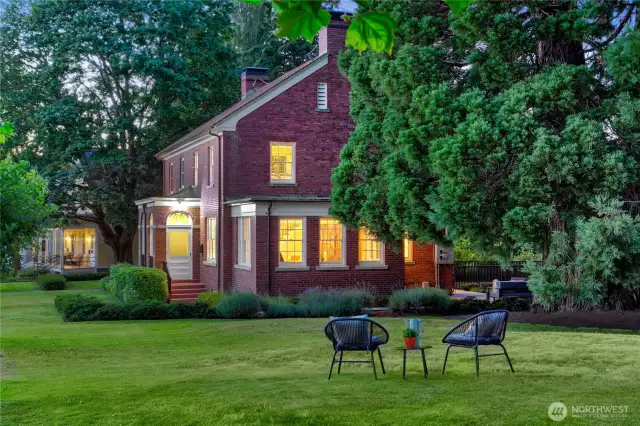 Evening descends over the private green, where a quiet moment beneath the sequoias becomes a daily ritual. Once grounds for military order, this lawn now invites slow conversation, laughter among friends, and the kind of stillness only possible when home is surrounded by forest, meadow, and sky.