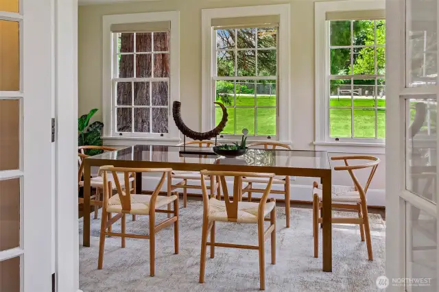 Through these original divided-light windows, your view opens not to a neighboring fence, but to a vast, private green—the kind of lawn where picnics, poetry readings, or impromptu soccer games unfold beneath the branches of old-growth trees. Dining here is a daily reminder of the land’s quiet grandeur.