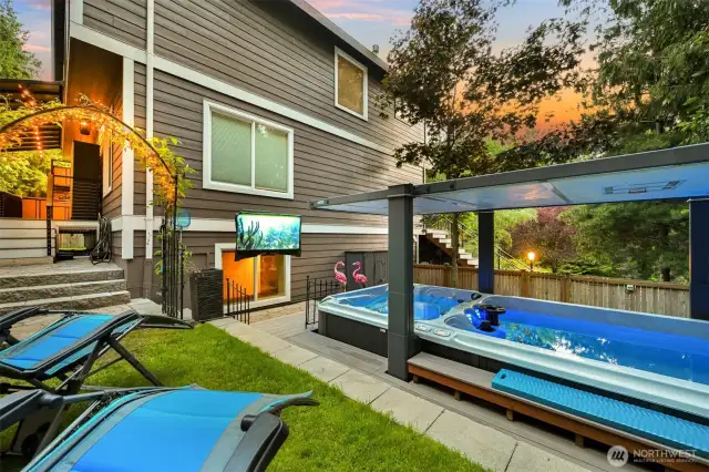 Hot tub/ lap pool with a powered top and a TV