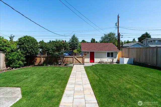 A private oasis in this wonderful, level and fenced yard with fresh lawn and blooming flower beds