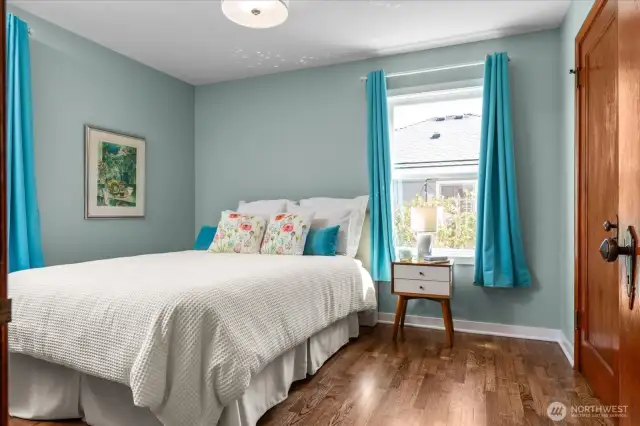 Sizable main floor bedroom with beautiful, refinished hardwood flooring and large closet