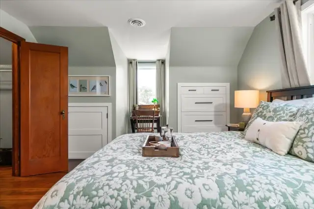 Added amenities: the primary suite is appointed with a desk alcove, offering peak-a-boo Puget Sound and Olympic Mountain Views, a walk-in closet and attic storage access
