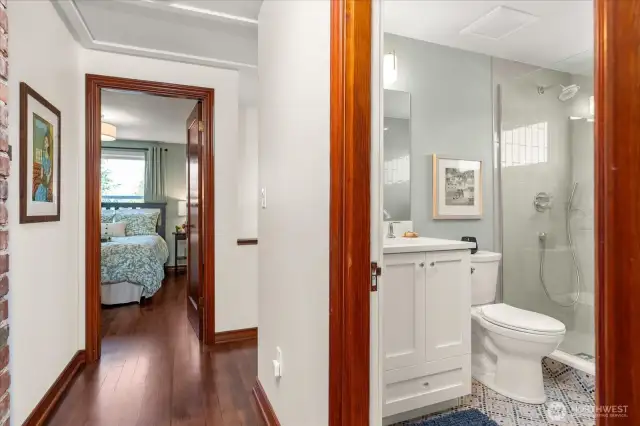Original wood doors with glass handles, and wood trim paired with light neutral-colored walls offers a modern, yet nostalgic feel
