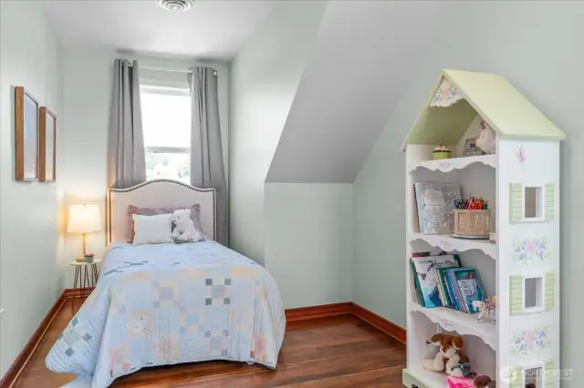 A room that allows for intimate spaces with interesting ceilings and cozy niches in this upstairs secondary bedroom