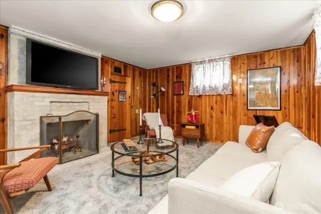 An attractive focal point in the downstairs family room, the working original fireplace with newly applied German Schemer treatment