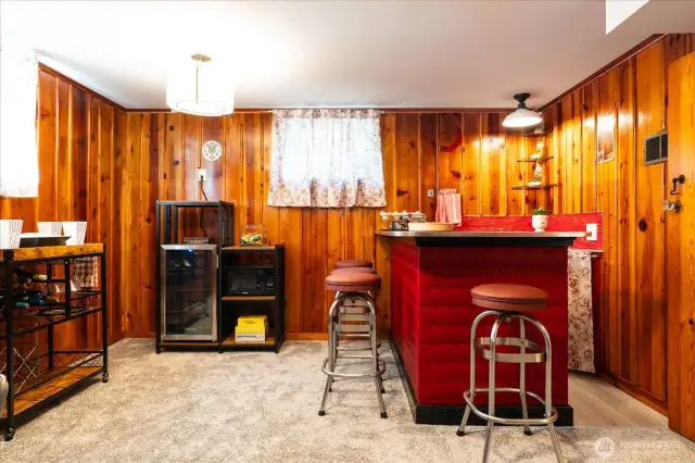 A wonderful place to "hang out", the lower level family room with original wet bar, perfect for game or movie room