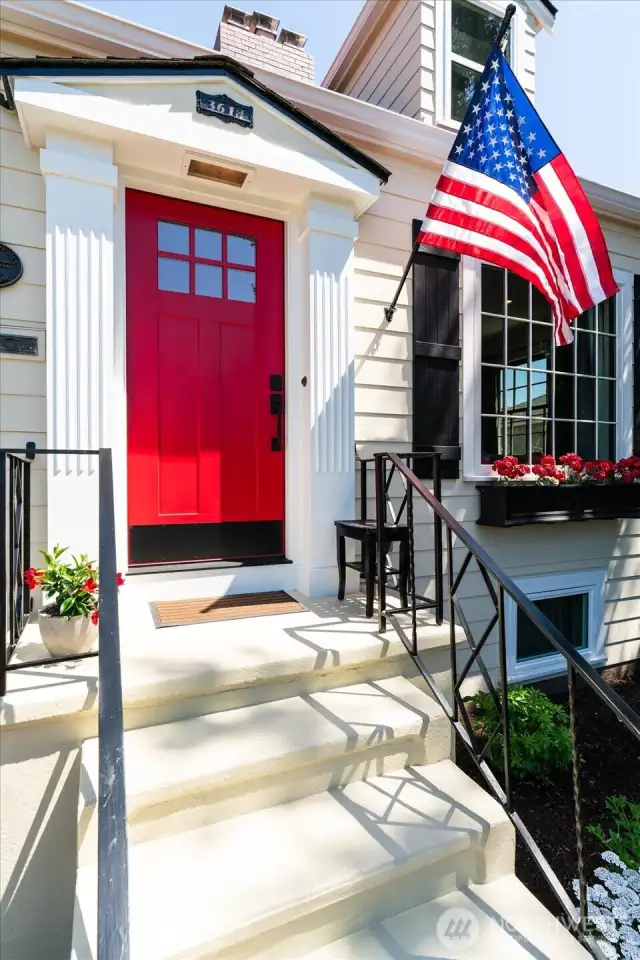 Pillared front porch and new craftsman front door welcome you inside