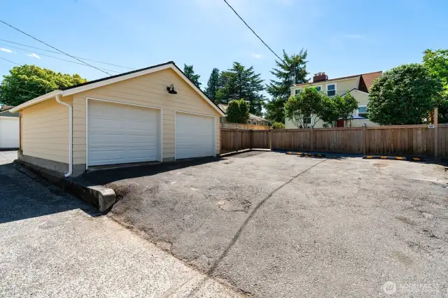 Two car detached garage with new roof and siding, and two dedicated parking spaces off alley