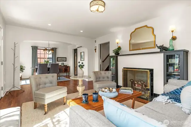 Arched entries and original wood burning fireplace, enhanced with custom built-ins and wood mantle, feels elegant and timeless