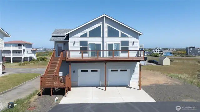 Home features a two-car garage plus RV parking alongside the home, with main living space above to capture the views.