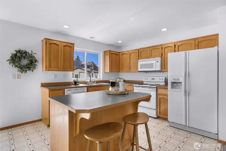 Kitchen has breakfast bar with additional seating