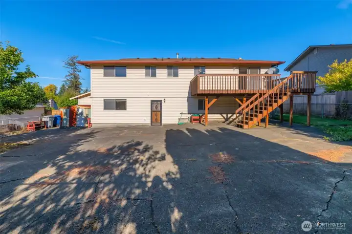 This photo is from the backyard looking towards the back of the home. Low maintenance large cement patio large enough for your own sport court, roller rink, place to gather friends and family.