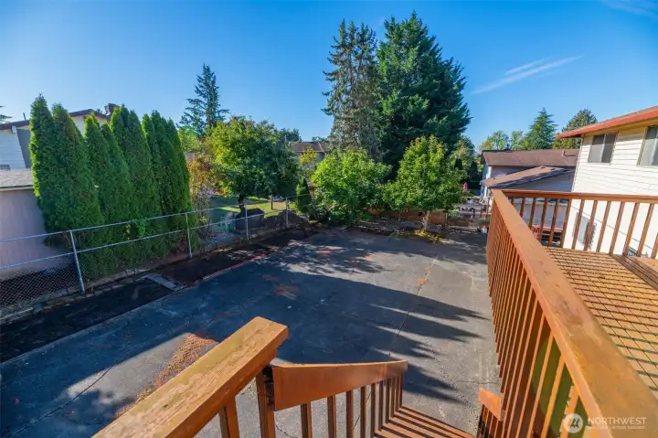 Here is a photo from the deck looking down towards this spacious backyard and the fig and asian pear trees in the  Southwest corner of this 7,592 sq ft lot.