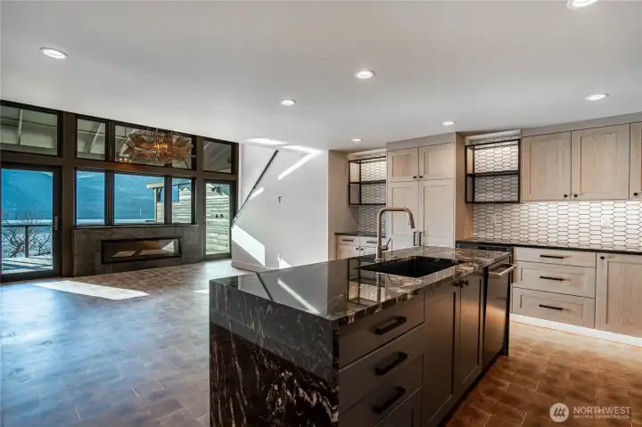 Fully renovated open floor plan with beautiful kitchen counters and luxury appliances. Kitchens opens to the dining area and living room with fireplace and amazing lake views.