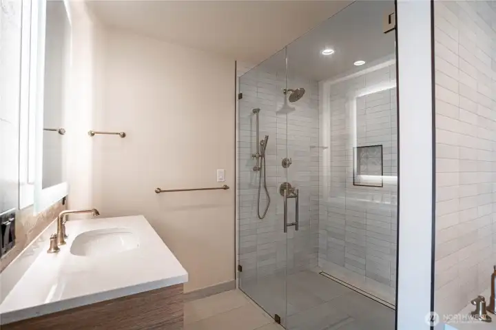 Oversized shower with massage fixtures and beautiful tile work.