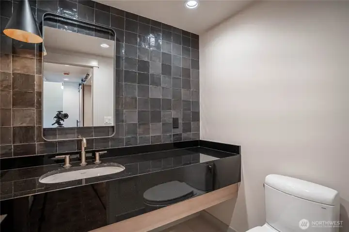 Stylish and modern half-bath near the entry area.