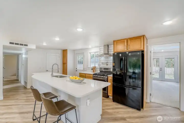 Step into a beautifully designed kitchen anchored by a striking 12-foot quartz island—an entertainer’s dream with generous space to gather, dine, and connect. Utility room off kitchen.