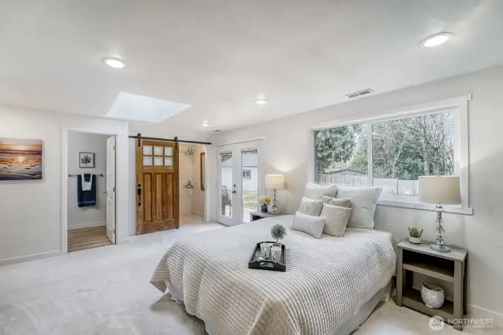 Retreat to a luxurious primary suite designed for comfort & style. This spacious haven features 2 generous closets with custom built in organizers, elegant touch, while French doors open directly to a private backyard deck, creating a seamless indoor-outdoor escape.