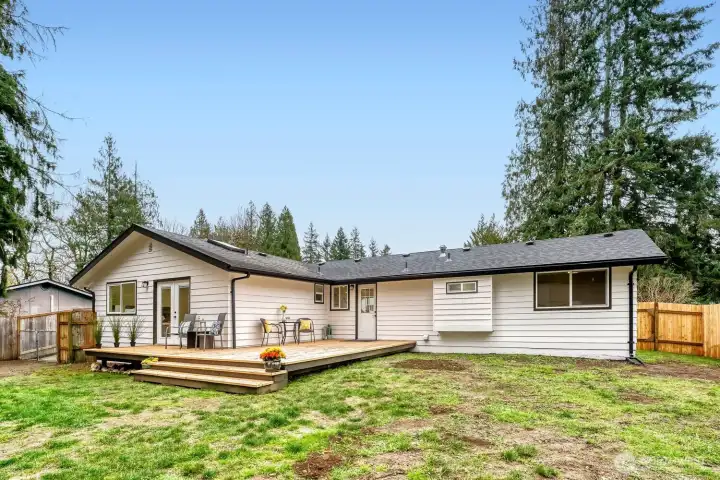 The expansive, fully fenced yard offers exceptional privacy, framed by mature trees and generous garden space perfect for growing, relaxing, or entertaining. Sunlight pours across the lot throughout the day, creating a bright, cheerful setting both inside and out.