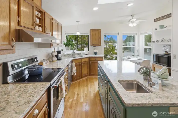 Stunning quartz counters, stainless steel appliances, a large island with a 2nd sink, plenty of cabinetry for storage