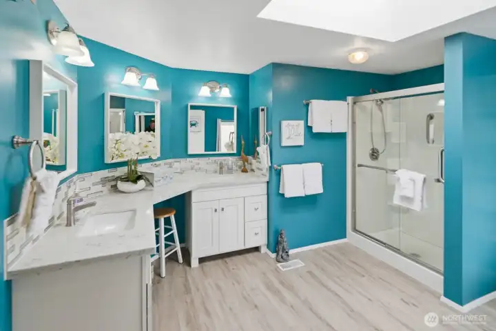 Incredible spa-like ensuite bathroom complete with dual vanity sinks, quartz countertops, a large walk-in shower, and an inviting freestanding soaking bathtub. Beautifully updated.