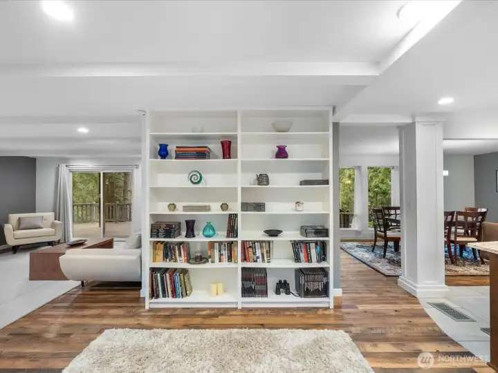 Versatile Open Living; this area features a stunning floor-to floor ceiling custom bookcase that elegantly defines the living and the dinning areas.