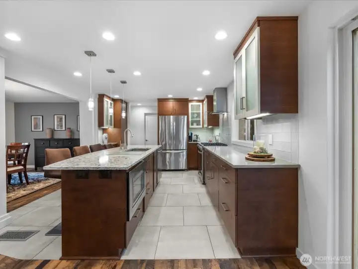 The chef's kitchen defines modern luxury with its quartz countertops, custom cabinetry and high-end SS appliances tailored to open concert entertaining.