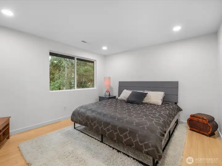 Bedroom #2 Serene retreat with bamboo flooring, forest views, modern recess lighting with brand new closet doors.
