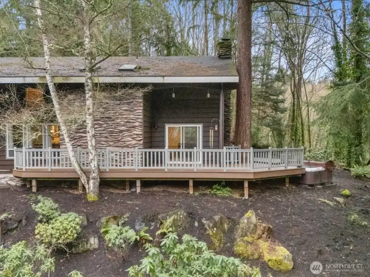 Embrace the ultimate in private luxury with this architectural masterpiece, where striking textured siding an expansive wraparound deck offer a seamless indoor/outdoor lifestyle nestled within a serene forest setting.