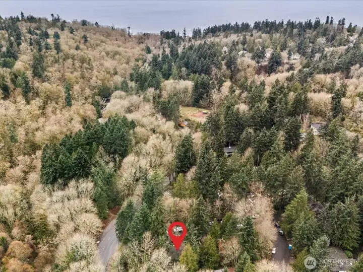 Location of the property with respect to Carkeek park. •   Set in a rare, park-like setting with peaceful natural views, offering a sense of privacy and tranquility rarely found in the city.    • Nestled in a secluded oasis, where the only sounds are birdsong and rustling evergreens.    • Ideally located near the 200-acre Carkeek Park watershed with miles of scenic trails, lush forests, and shoreline access.    • The sandy beach of Puget Sound is just a short distance away, providing effortless access to waterfront sunsets and coastal walks.