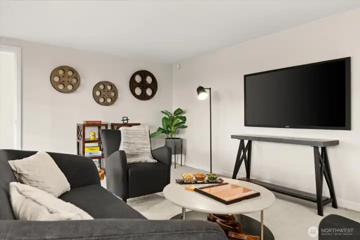 This spacious lower-level recreation room is ideal for a large TV or projection screen, making it perfect for movie nights