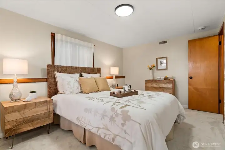 Nicely sized bedroom on lower level, could accommodate a queen or king-sized bed and offers wrap around windows