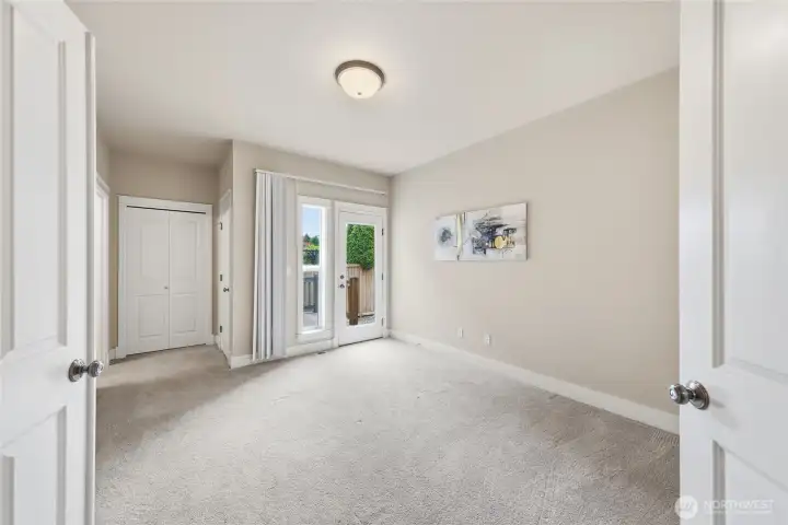 Main-level primary bedroom with private deck and separate entrance—ideal for guests or multi-generational living