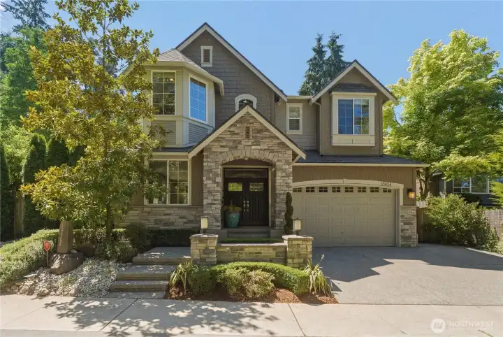 Private corner-lot setting wrapped in mature evergreens, featuring timeless Murray Franklyn architecture, a 3-car tandem garage, and a fully fenced lot with dual side gates