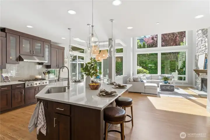 From the kitchen entrance, the home opens to the family room and breakfast nook, all framed by peaceful views of the green space outside