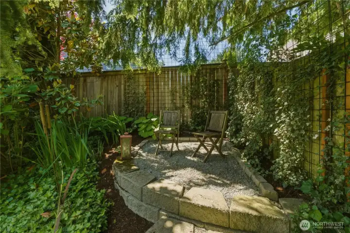 Step outside the main floor office to the mound, a peaceful little perch with views across the whole garden