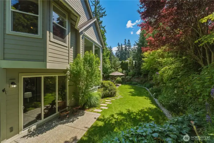 The view from the mound showcases the beautifully landscaped backyard and peaceful garden setting