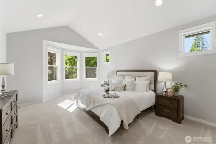 As you arrive on the second floor, double doors frame the large primary bedroom with vaulted ceilings. Natural light pours in from the bay windows and additional, north facing windows. Brand new carpet throughout the entire second floor