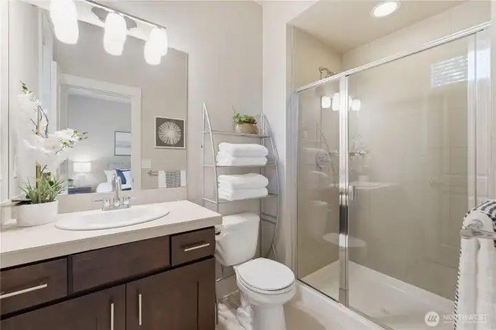 The second upstairs ensuite includes a well-proportioned bathroom with beautiful tile finishes and generous storage space