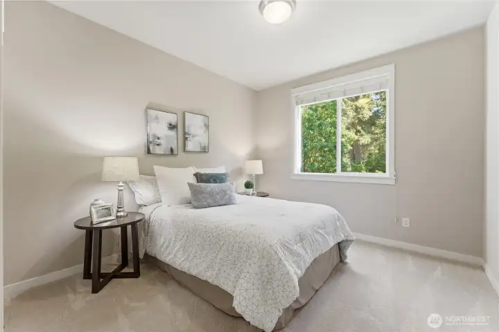 This is one of the two south-facing bedrooms, offering peaceful views of the garden. Every bedroom on the second floor is outfitted with California Closet organizers