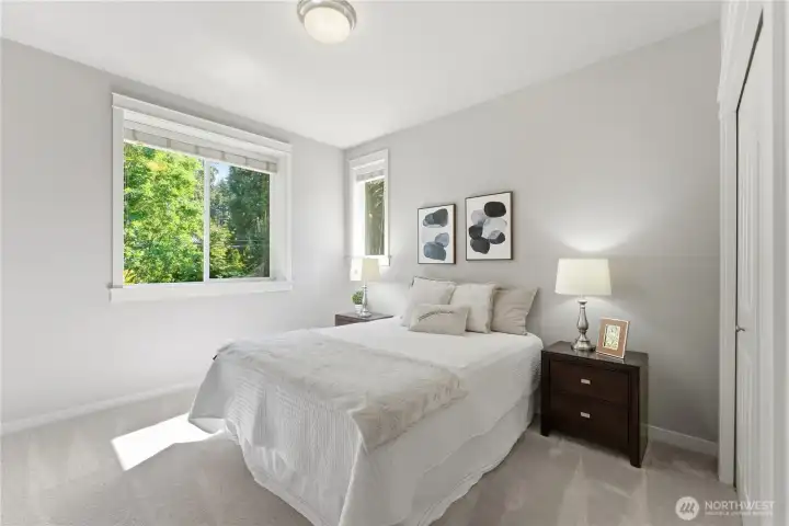 One of the two south facing bedrooms, filled with soft natural light and views of the garden