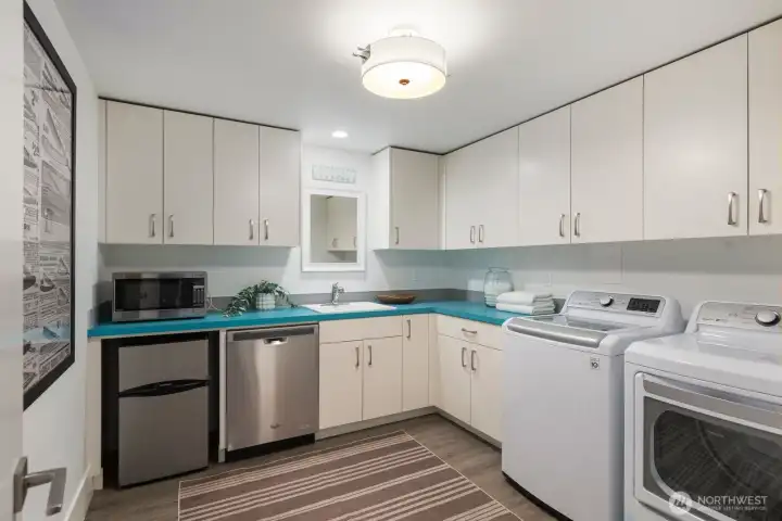 lower level laundry room with extra accessories such as a dishwasher, refrigerator and sink. lower level laundry room with extra accessories such as a dishwasher, refrigerator and sink.